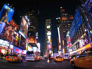 Times Square New York City Night Scene with Bright Billboards and Yellow Taxis HD wallpaper
