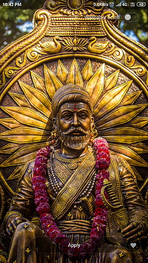 Chhatrapati Shivaji Maharaj Bronze Statue with Marigold Garland and Golden Sunburst Halo HD phone wallpaper