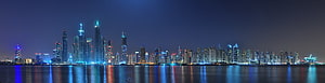 Panoramic Night Skyline of Dubai Marina with Illuminated Skyscrapers and Water Reflections HD wallpaper