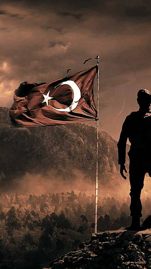 Turkish Soldier Silhouette Standing on Rocky Cliff with National Flag in Windy Mountain Landscape HD phone wallpaper