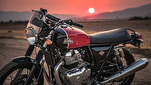 Royal Enfield Interceptor 650 motorcycle parked in a desert landscape at sunset HD wallpaper