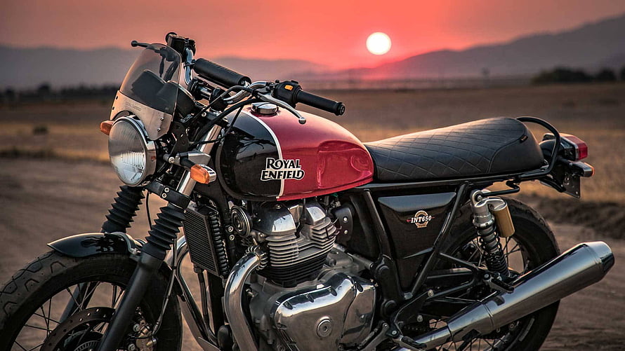Royal Enfield Interceptor 650 motorcycle parked in a desert landscape at sunset HD wallpaper