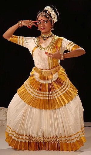 Mohiniyattam Dancer in Traditional Gold and White Costume with Elaborate Jewelry HD phone wallpaper
