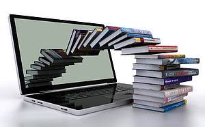 Laptop with Books Emerging from Screen Concept for Online Learning and Digital Education HD wallpaper