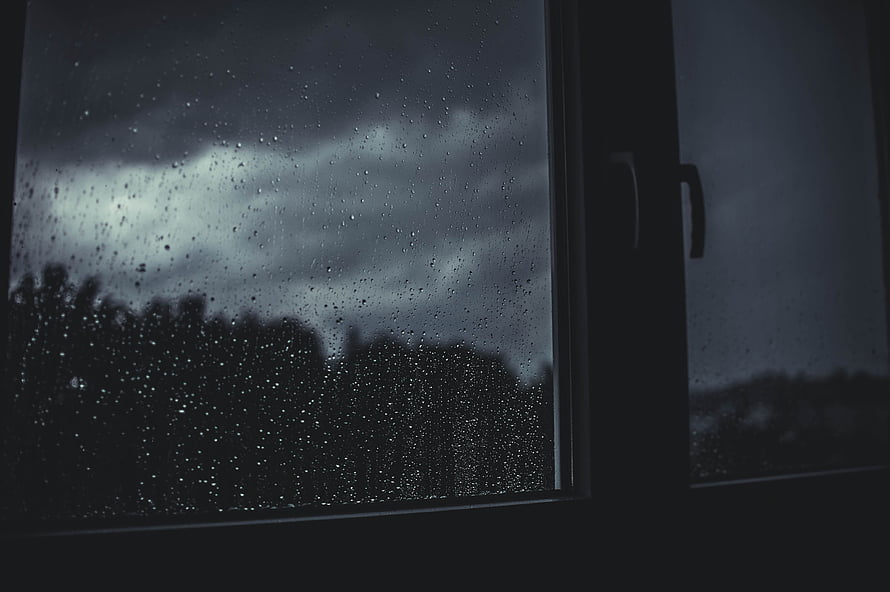 Moody Rainy Day View Through a Window with Dark Stormy Sky and Blurred Trees HD wallpaper
