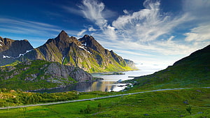 Dramatic Fjord Landscape with Steep Green Mountains and Calm Water HD wallpaper