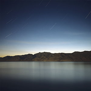 Star Trails Over Calm Lake and Mountain Range at Twilight HD phone wallpaper