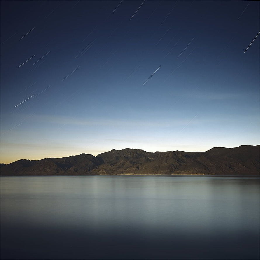 Star Trails Over Calm Lake and Mountain Range at Twilight HD phone wallpaper