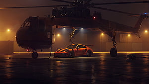Orange Porsche 911 GT2 RS parked beneath a military helicopter in a foggy hangar at night HD wallpaper