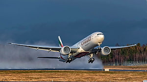 Emirates Boeing 777 Passenger Jet Taking Off From Runway In Dramatic Stormy Sky HD wallpaper