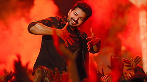Vijay performing in a fiery red-lit concert scene with outstretched hands HD wallpaper