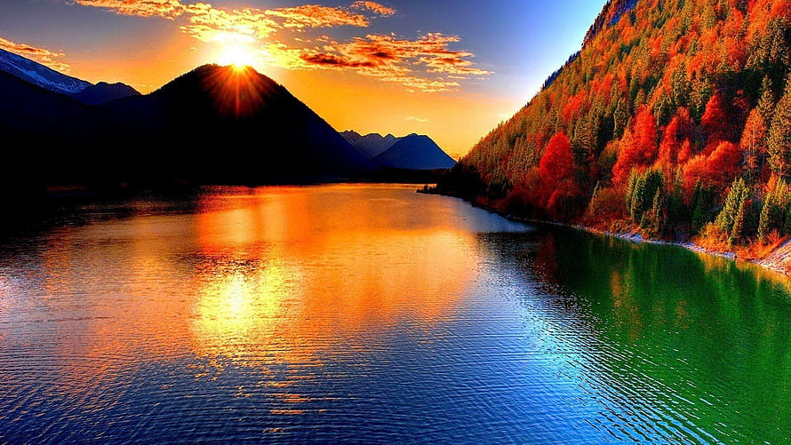 Vibrant Autumn Lake at Sunset with Mountain Silhouettes and Golden Reflections HD wallpaper
