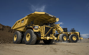 Caterpillar 793F Mining Dump Truck and 994H Wheel Loader at Work in Open Pit Mine HD wallpaper