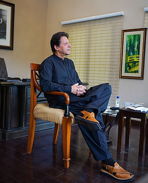Imran Khan Seated in Formal Black Attire Within an Elegant Office Setting HD phone wallpaper