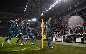Cristiano Ronaldo and Real Madrid teammates celebrating a goal at the Santiago Bernabéu stadium HD wallpaper