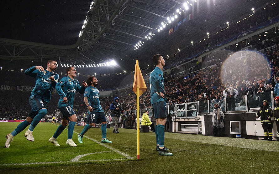 Cristiano Ronaldo and Real Madrid teammates celebrating a goal at the Santiago Bernabéu stadium HD wallpaper
