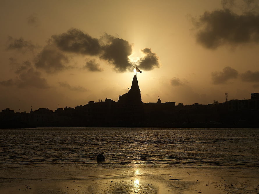 Dwarkadhish Temple Silhouette at Sunset Over the River in Dwarka HD wallpaper