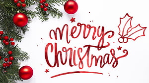 Festive Christmas Greeting With Pine Branches, Red Ornaments, and Calligraphy on White Background HD wallpaper