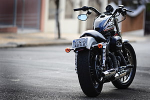 Rear View of a Custom Harley Davidson 883 Motorcycle Parked on an Urban Street HD wallpaper