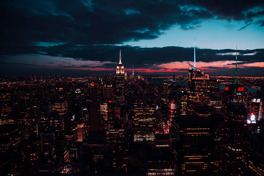 New York City Skyline at Dusk with Empire State Building and Dramatic Clouds HD wallpaper