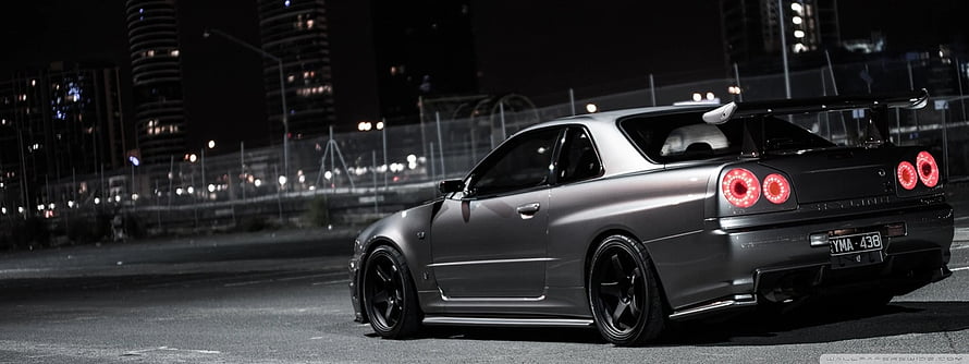 Modified Nissan Skyline GT-R R34 Night City Street Scene HD wallpaper