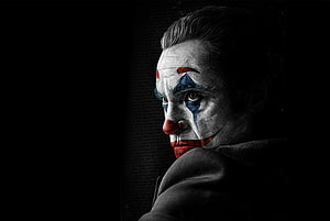 Joaquin Phoenix as The Joker in dramatic clown makeup with dark moody lighting and textured background HD wallpaper