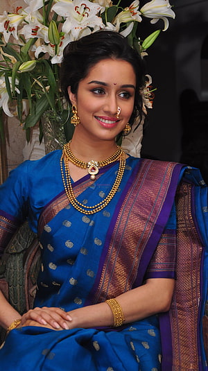 Shraddha Kapoor in a blue silk saree with gold jewelry and white lilies HD phone wallpaper