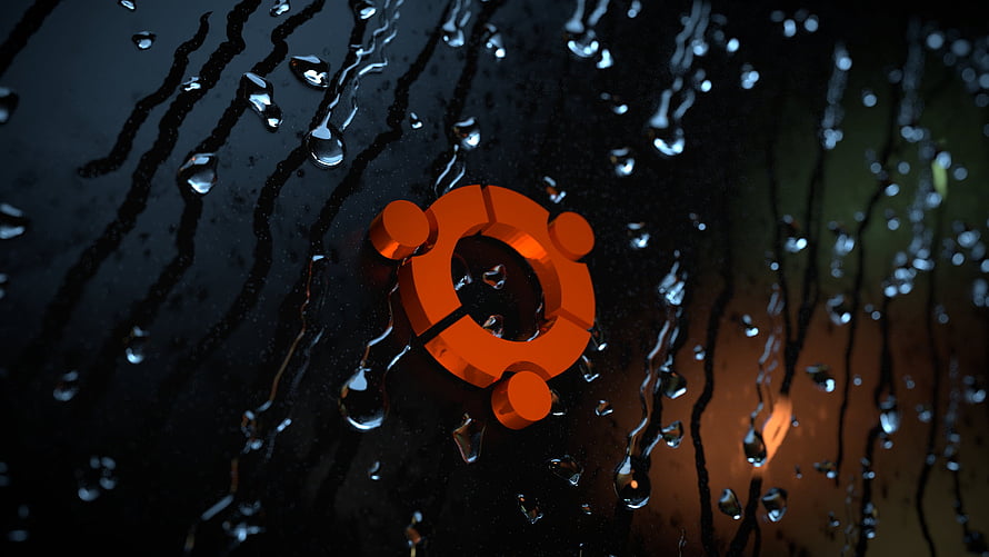 Ubuntu Logo on Wet Black Surface with Rain Droplets and Orange Glow HD wallpaper