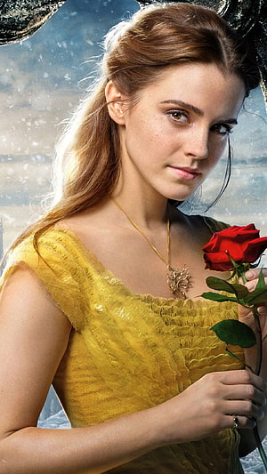 Emma Watson as Belle in Beauty and the Beast holding a red rose in a yellow gown HD phone wallpaper