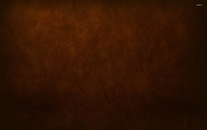 Dark Brown Leather Texture Background with Subtle Grain and Vignette HD wallpaper