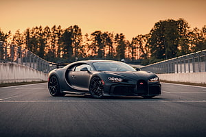 Matte Black Bugatti Chiron Pur Sport on a Race Track at Sunset HD wallpaper