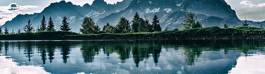 Serene Mountain Lake Reflection with Pine Trees and Snow-Capped Peaks HD wallpaper