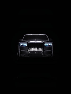 Rolls-Royce Phantom Front View with Illuminated Headlights Against Black Background HD phone wallpaper