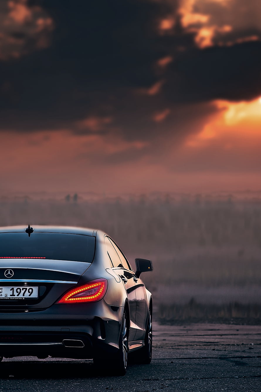 Mercedes-Benz CLS Rear View Against Dramatic Sunset Sky HD phone wallpaper