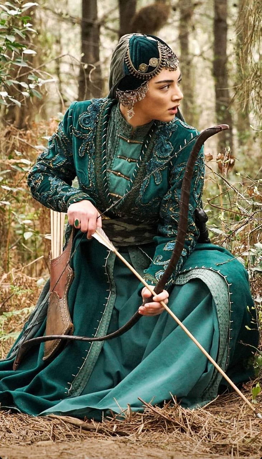 Kuruluş Osman Archery Scene: Woman in Green Velvet Attire with Bow and Arrow in Forest HD phone wallpaper