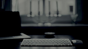Minimalist Dark Workspace With Wireless Keyboard And Mouse On Desk HD wallpaper