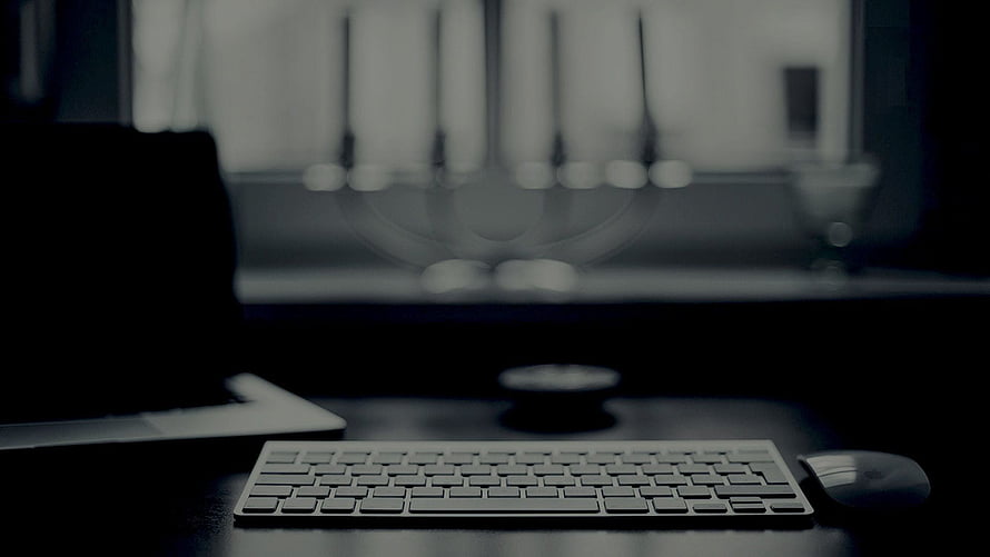 Minimalist Dark Workspace With Wireless Keyboard And Mouse On Desk HD wallpaper