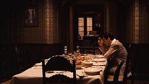 Michael Corleone at a dimly lit dining table in The Godfather II HD wallpaper