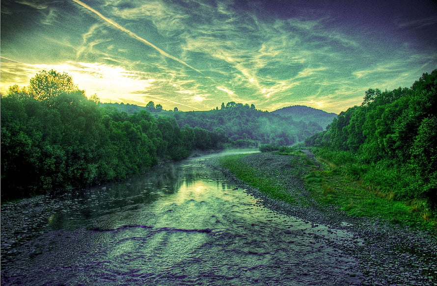 Serene River Valley at Dusk with Lush Forests and Dramatic Clouds HD wallpaper