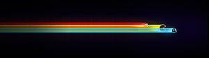 Pac-Man and Ghosts on Glowing Rainbow Trails Against a Dark Background HD wallpaper