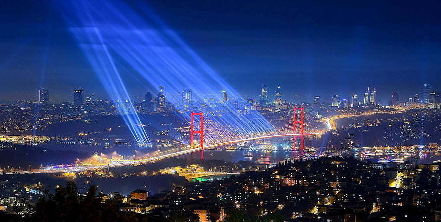 Istanbul Night Skyline with Bosphorus Bridge and Blue Light Beams HD wallpaper