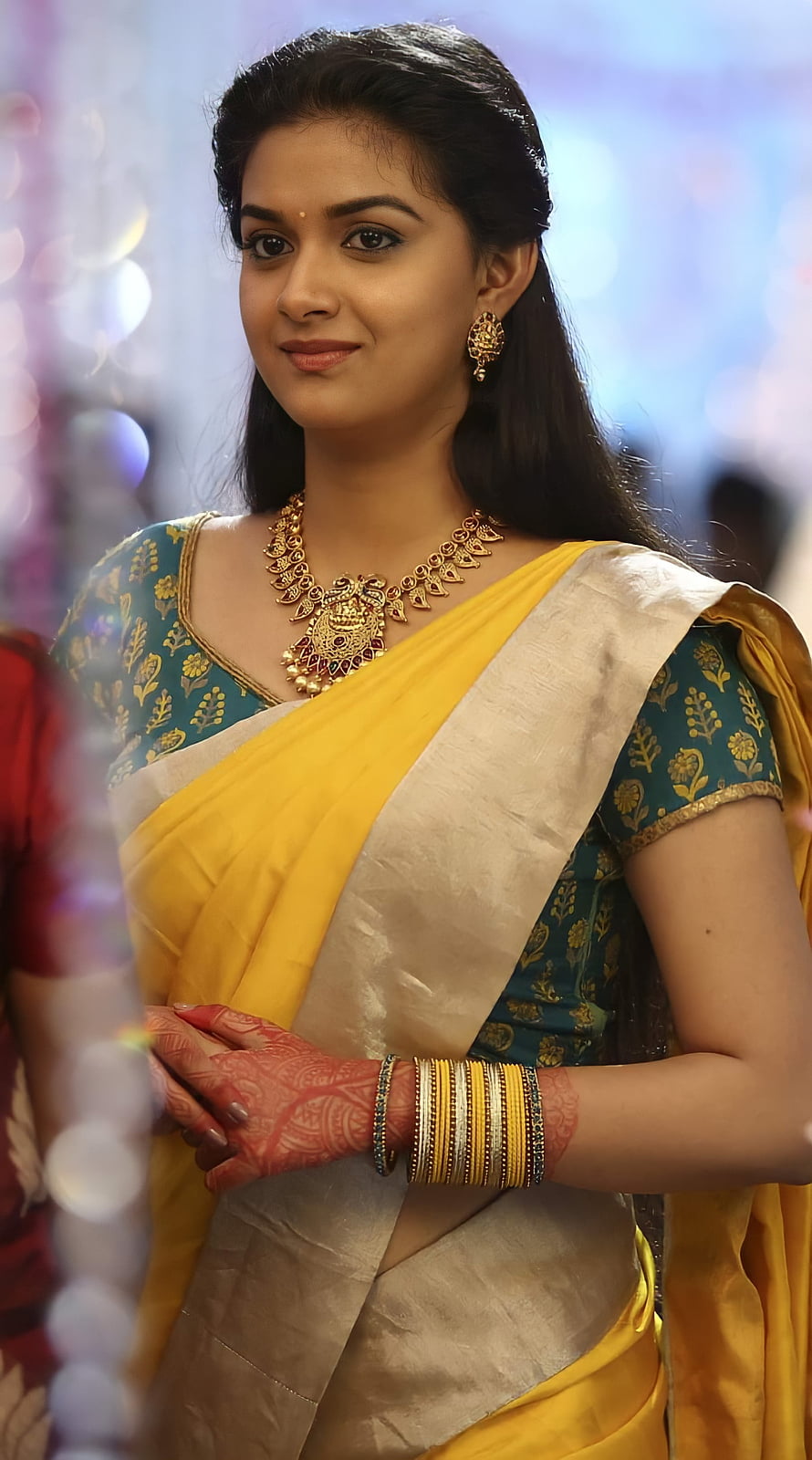 Keerthi Suresh in a yellow and teal saree with traditional gold jewelry and henna HD phone wallpaper