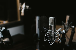 Professional Condenser Microphone in Dark Recording Studio with Pop Filter HD wallpaper