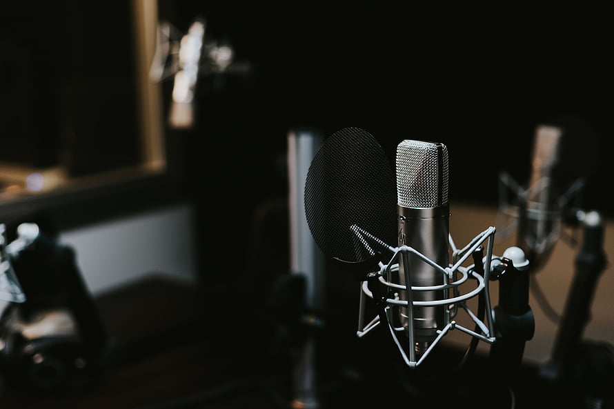 Professional Condenser Microphone in Dark Recording Studio with Pop Filter HD wallpaper