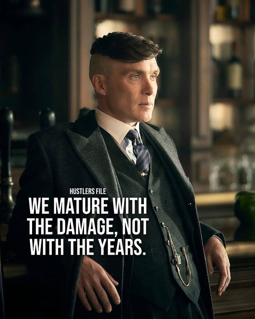Tommy Shelby in a dark three-piece suit with a pocket watch chain in a dimly lit bar HD phone wallpaper