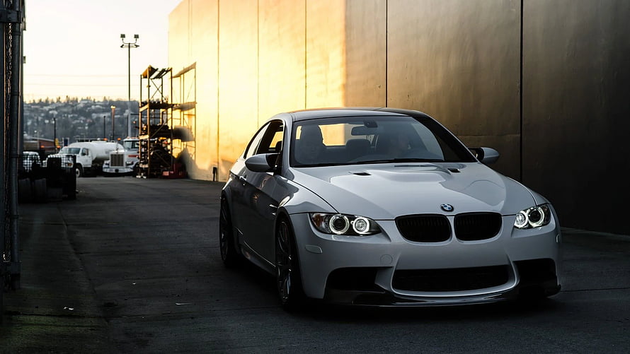Silver BMW M3 E92 Coupe Parked in Industrial Setting at Golden Hour HD wallpaper