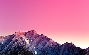 Pink Sky Over Snow-Capped Mountain Peaks at Sunset HD wallpaper