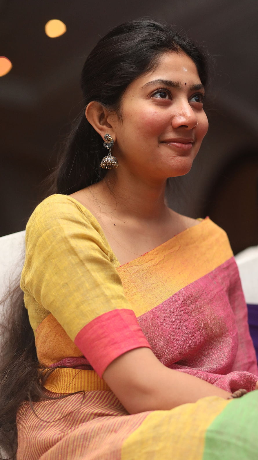 Sai Pallavi in a vibrant yellow and pink saree with traditional jhumka earrings HD phone wallpaper