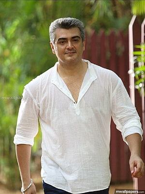 Ajith Kumar in a white linen shirt with grey hair standing outdoors HD phone wallpaper