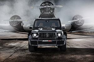 Black Brabus 800 Widestar SUV Parked in Front of Vintage Propeller Aircraft HD wallpaper